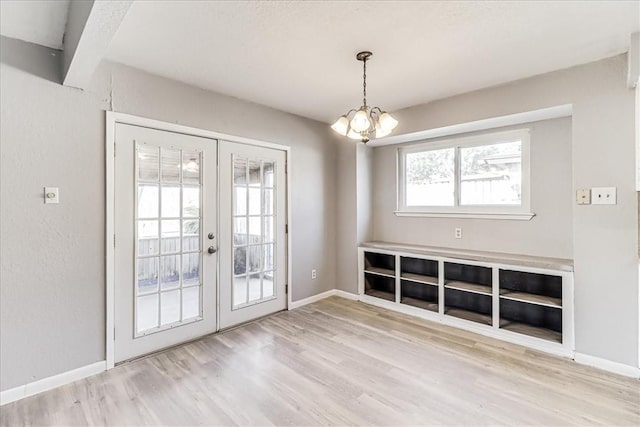 6701 Meadowbreeze Pkwy, Corpus Christi, TX 78414 - unfurnished dining area featuring french doors, wood finished floors, a chandelier, and baseboards