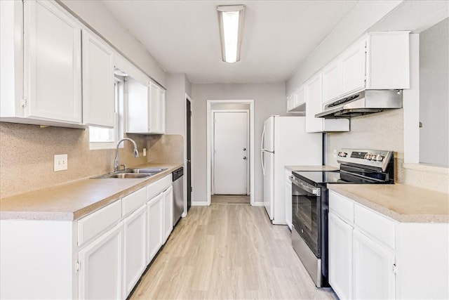 6701 Meadowbreeze Pkwy, Corpus Christi, TX 78414 - kitchen with stainless steel appliances, under cabinet range hood, a sink, and light countertops