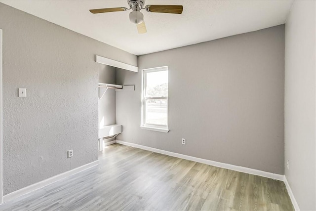 6701 Meadowbreeze Pkwy, Corpus Christi, TX 78414 - unfurnished bedroom featuring wood finished floors, a closet, baseboards, and ceiling fan