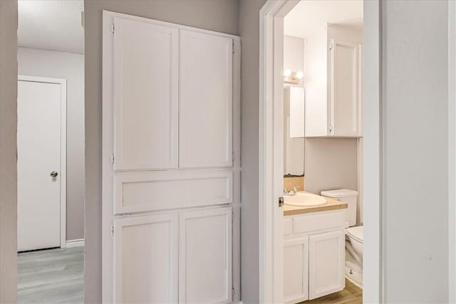 6701 Meadowbreeze Pkwy, Corpus Christi, TX 78414 - bathroom featuring vanity, wood finished floors, and toilet