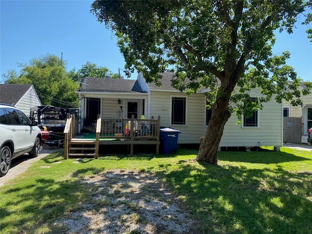 view of front of home featuring a wooden deck and a front lawn