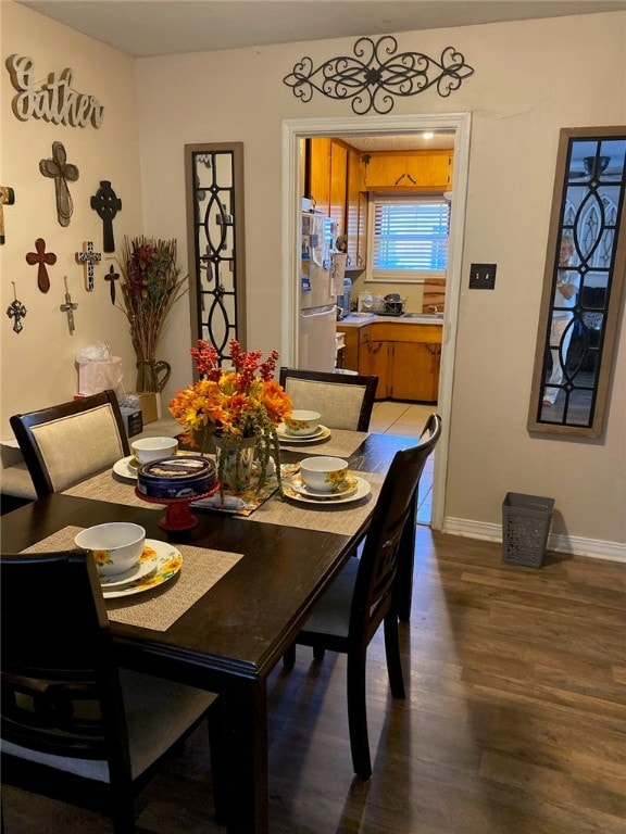 dining space with wood-type flooring