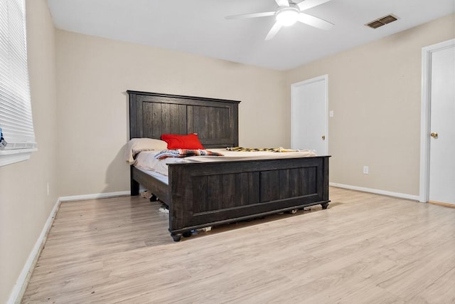 bedroom with ceiling fan and light hardwood / wood-style flooring