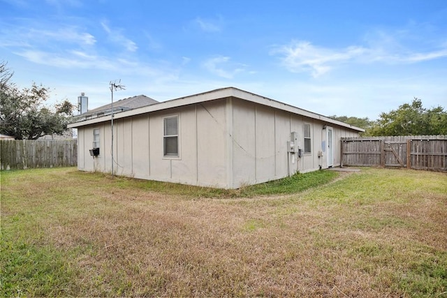 view of side of home featuring a yard