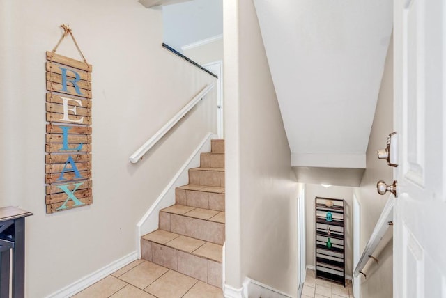 stairs featuring tile patterned flooring and baseboards