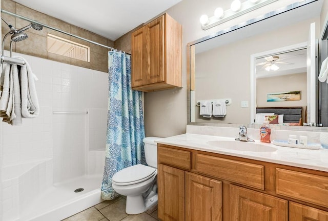 bathroom with tiled shower, toilet, ensuite bathroom, tile patterned floors, and vanity