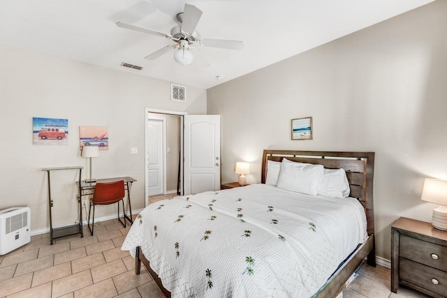 bedroom with a ceiling fan, visible vents, baseboards, and light tile patterned flooring