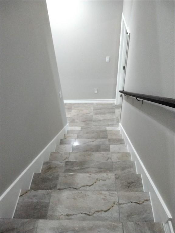 3018 Greenwood Dr, Corpus Christi, TX 78405 - staircase with marble finish floor and baseboards