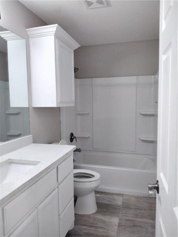 3018 Greenwood Dr, Corpus Christi, TX 78405 - full bath featuring toilet, vanity, wood finished floors, visible vents, and shower / bath combination
