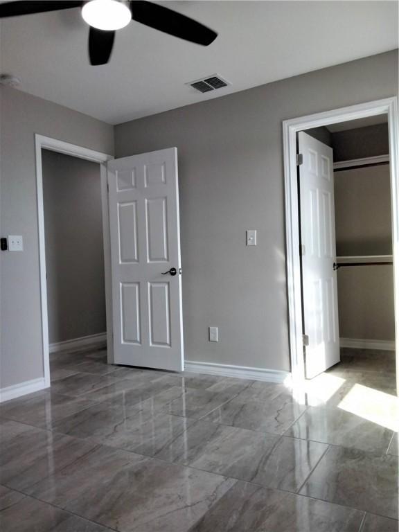 3018 Greenwood Dr, Corpus Christi, TX 78405 - unfurnished bedroom featuring marble finish floor, baseboards, ceiling fan, and visible vents