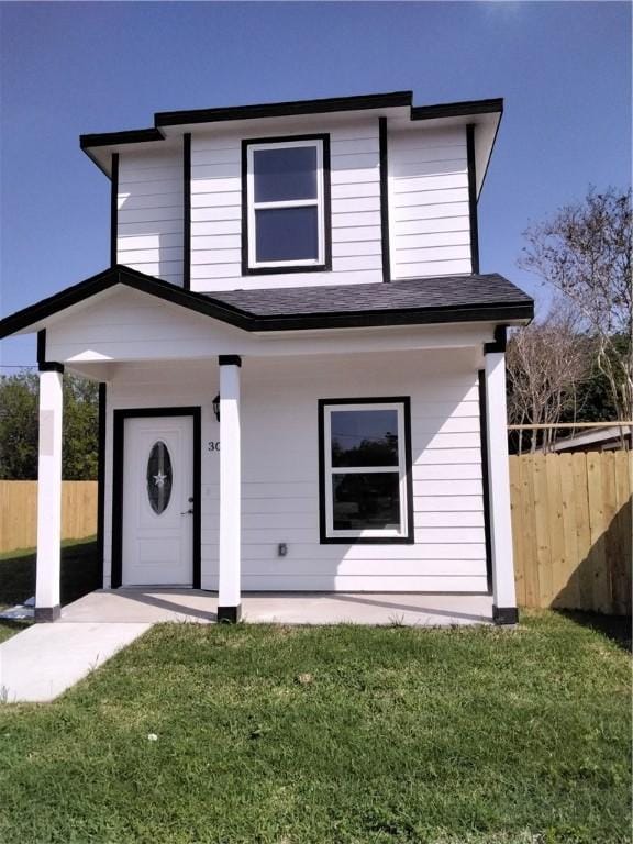 3018 Greenwood Dr, Corpus Christi, TX 78405 - view of front of home with roof with shingles, a front yard, and fence