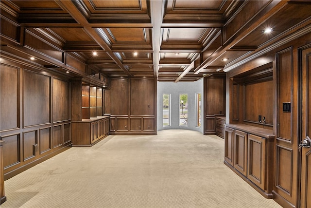 interior space featuring coffered ceiling, beamed ceiling, light carpet, and ornamental molding