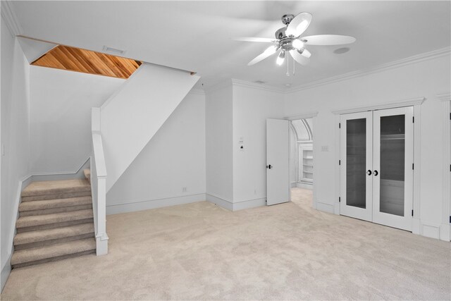 interior space with ornamental molding, french doors, light colored carpet, and ceiling fan