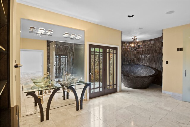 interior space with french doors and a chandelier