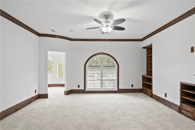 unfurnished living room featuring carpet flooring, ceiling fan, and crown molding