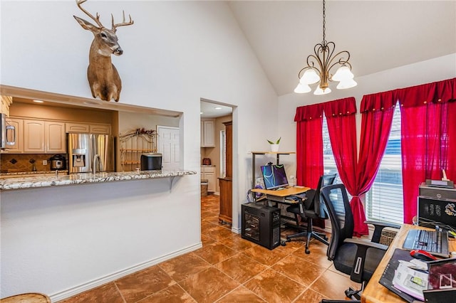 office area featuring an inviting chandelier, baseboards, high vaulted ceiling, and dark tile patterned flooring