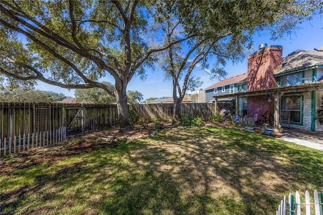 view of yard featuring a patio area and a fenced backyard