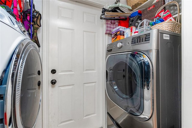 washroom with laundry area and washer / dryer