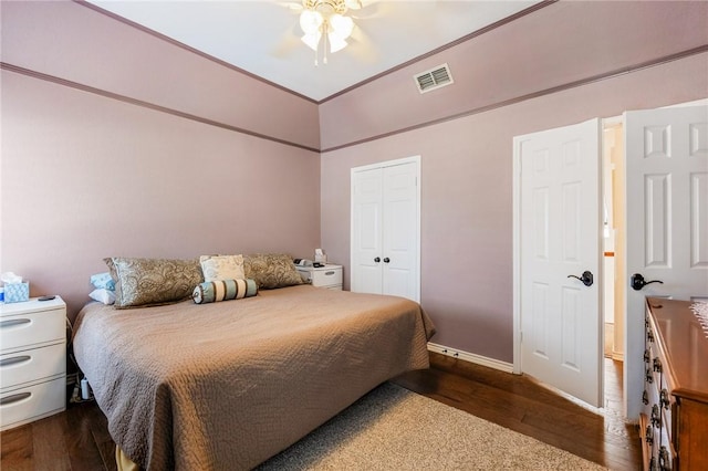 bedroom featuring a closet, visible vents, baseboards, and wood finished floors