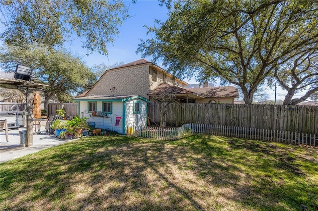 view of property exterior with a yard, a patio, and fence private yard