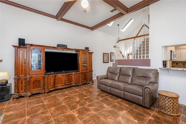 living room with beamed ceiling, stairway, a skylight, and visible vents