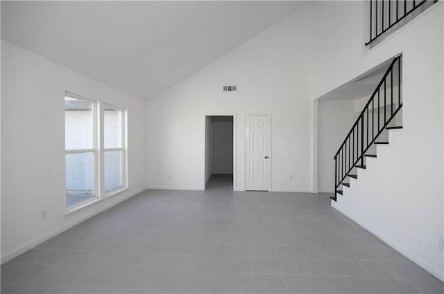 4802 Eider Dr, Corpus Christi, TX 78413 - unfurnished living room with high vaulted ceiling and stairway