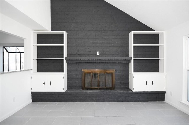 4802 Eider Dr, Corpus Christi, TX 78413 - unfurnished living room with a brick fireplace, tile patterned flooring, and vaulted ceiling