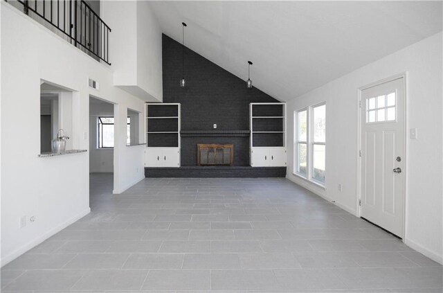 4802 Eider Dr, Corpus Christi, TX 78413 - unfurnished living room with a brick fireplace and high vaulted ceiling