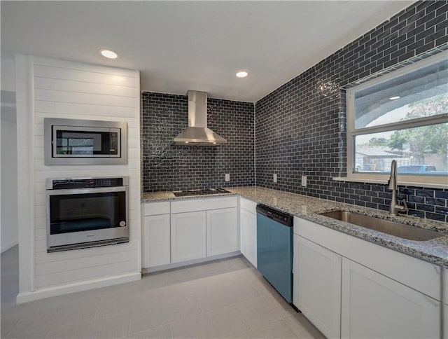 4802 Eider Dr, Corpus Christi, TX 78413 - kitchen featuring stainless steel appliances, wall chimney exhaust hood, backsplash, light stone counters, and recessed lighting