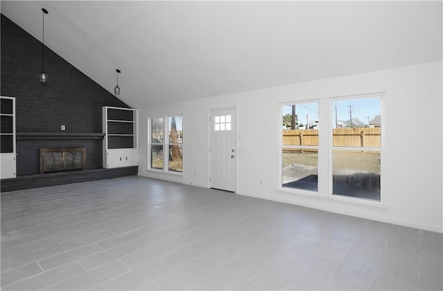 4802 Eider Dr, Corpus Christi, TX 78413 - unfurnished living room featuring high vaulted ceiling and a brick fireplace