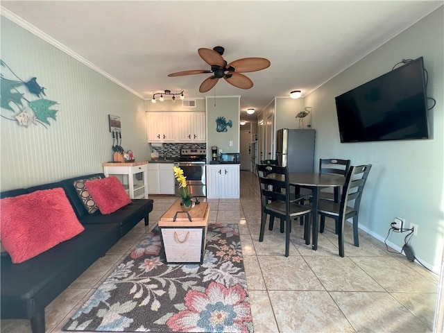 living room with ceiling fan, light tile patterned floors, and crown molding