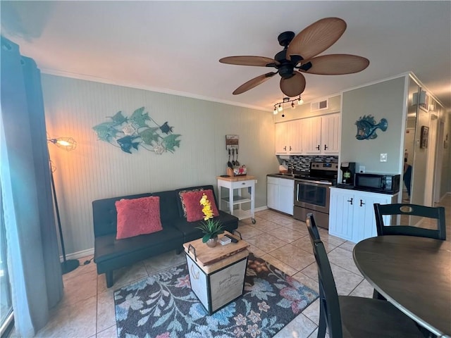 tiled living room with ceiling fan and ornamental molding