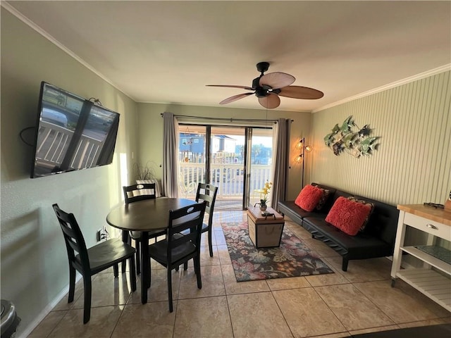 tiled dining room featuring ceiling fan and crown molding