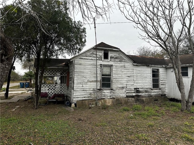 view of side of home with a lawn