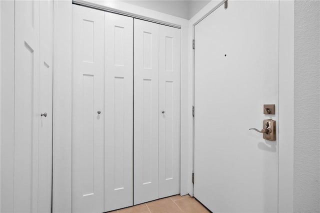 unfurnished bedroom featuring a closet and light tile patterned floors