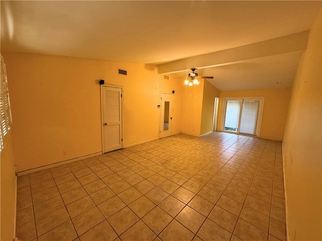 empty room with light tile patterned flooring, ceiling fan, and lofted ceiling with beams