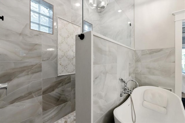 4903 State Highway 361 Unit 18, Port Aransas, TX 78373 - full bathroom with a freestanding bath, tile walls, and a walk in shower