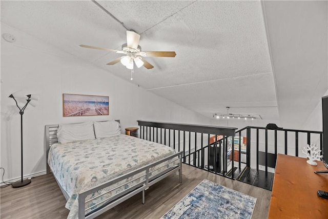 14300 S Padre Island Dr S Unit 220C, Corpus Christi, TX 78418 - bedroom with wood finished floors, a textured ceiling, and vaulted ceiling