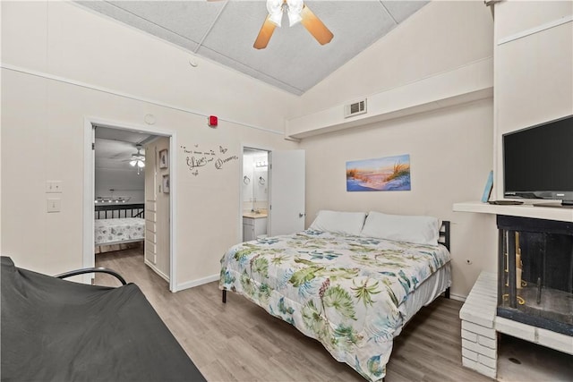 14300 S Padre Island Dr S Unit 220C, Corpus Christi, TX 78418 - bedroom with wood finished floors, lofted ceiling, a fireplace, ensuite bath, and ceiling fan