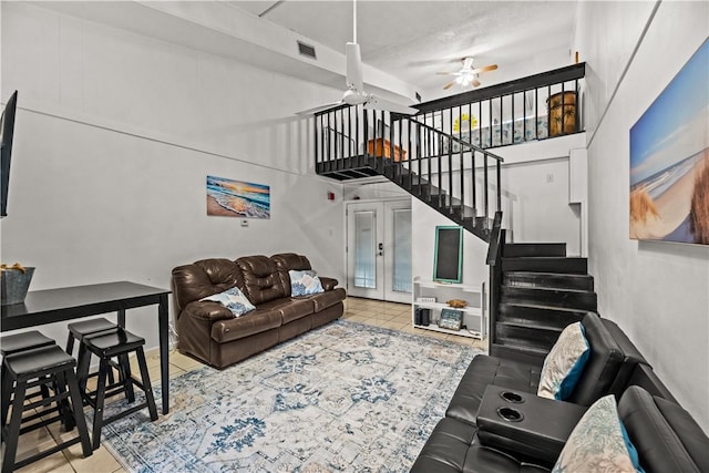 14300 S Padre Island Dr S Unit 220C, Corpus Christi, TX 78418 - tiled living room featuring a ceiling fan, stairway, french doors, and a towering ceiling