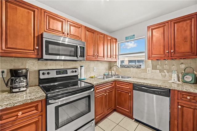 14300 S Padre Island Dr S Unit 220C, Corpus Christi, TX 78418 - kitchen featuring stainless steel appliances, backsplash, and brown cabinets