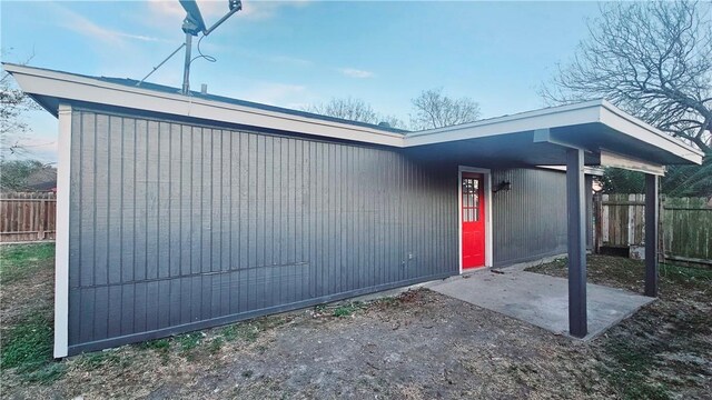 view of exterior entry with fence