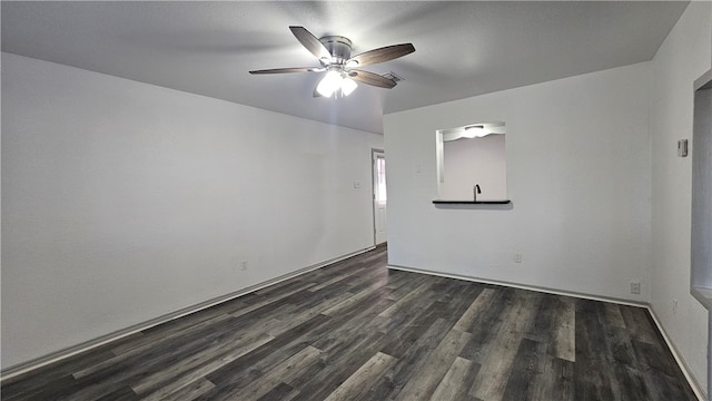 unfurnished room with ceiling fan and dark wood-style flooring