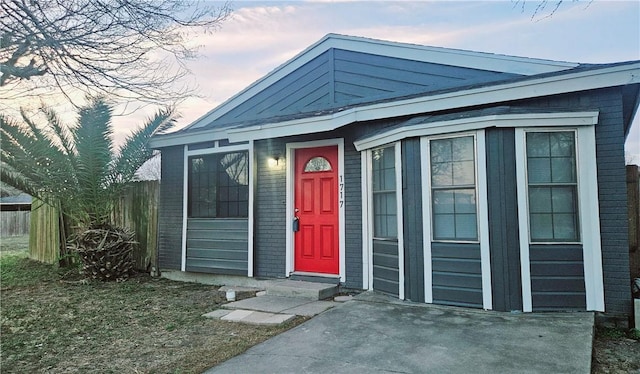 view of front of house featuring fence