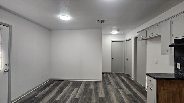 interior space with visible vents and dark wood finished floors