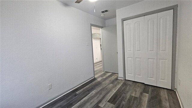 full bathroom with hardwood / wood-style floors, shower / bath combination with curtain, toilet, and vanity