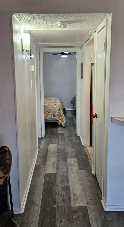 hallway with dark wood-type flooring