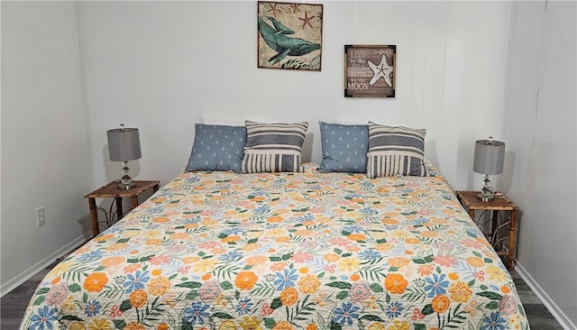 bedroom with dark wood-type flooring