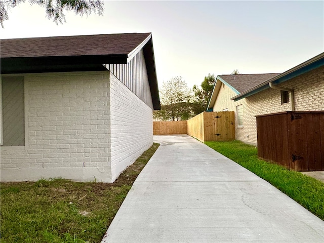 property exterior at dusk featuring a patio area