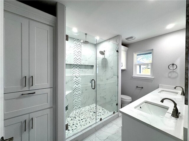 bathroom with walk in shower, vanity, and toilet